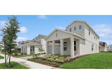 Charming two-story home showcasing an attached garage, manicured lawn, and inviting curb appeal at 13175 Telsen St # 40, Winter Garden, FL 34787