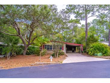 Charming single-story home featuring a well-maintained front yard with mature trees and a long driveway at 149 E Plantation Blvd, Lake Mary, FL 32746