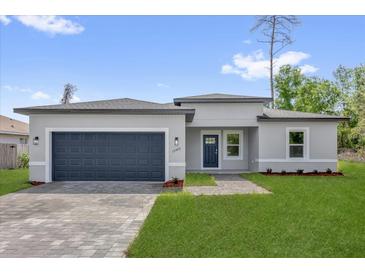 Charming single-Gathering home showcasing a well-manicured lawn and a brick driveway at 15443 Sw 21St Ct, Ocala, FL 34473