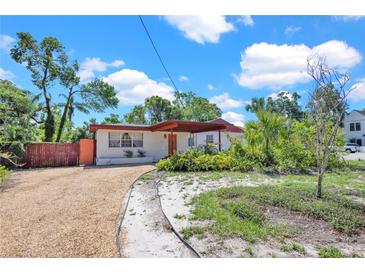Charming single-story home with a gravel driveway and covered carport, showcasing its inviting curb appeal at 1705 Virginia Dr, Orlando, FL 32803