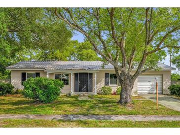 Charming single-story home with mature landscaping and a metal roof at 2357 E Dana Dr, Deltona, FL 32738