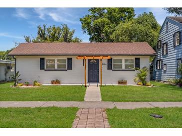 Charming single-story home with a light-brick exterior, well-manicured lawn, and inviting entrance at 612 Florida Ave, St Cloud, FL 34769