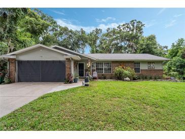 Charming single Gathering home with a well-manicured lawn and beautiful landscaping at 750 W May St, Deland, FL 32720