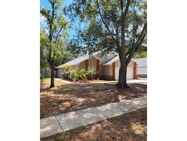Charming single-story home with manicured landscaping and mature trees at 2723 Talladega Dr, Orlando, FL 32826