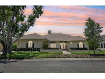 Charming single-story home with brick and concrete exterior, manicured landscaping, and a tile roof at 356 N Spaulding Cv, Lake Mary, FL 32746