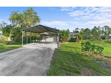 Charming single-story home featuring a covered parking area and well-maintained landscaping on a sunny day at 6975 Maverick Trl, St Cloud, FL 34771