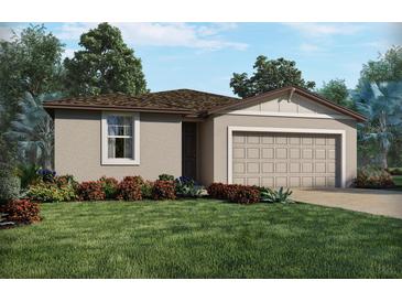 Charming single-story home with a well-manicured lawn, colorful flowers and a two car garage at 1134 Cumberland Trail Dr, Lake Hamilton, FL 33851