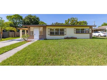 Charming single-story home featuring a well-maintained lawn and classic curb appeal on a sunny day at 2222 Catherine St, Kissimmee, FL 34741