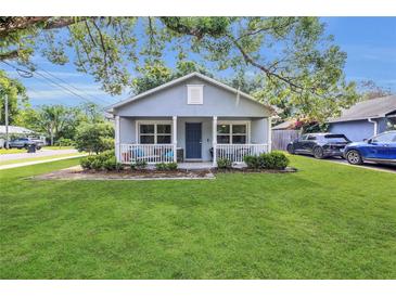 Charming single-story home with a well-manicured lawn and inviting front porch at 2401 Mayer St, Orlando, FL 32806
