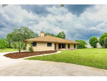 Charming ranch-style home with well-maintained lawn and landscape featuring mature trees and lovely curb appeal at 3443 Wild Myrtle Ct, Windermere, FL 34786