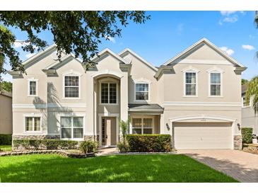 Beautiful two-story home featuring a well-manicured lawn and an attached two-car garage at 3868 Whitewood Ct, Oviedo, FL 32766