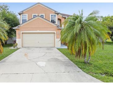 Inviting two-story home featuring a neutral stucco exterior and attached two-car garage at 437 Bridgewater Court, Kissimmee, FL 34758
