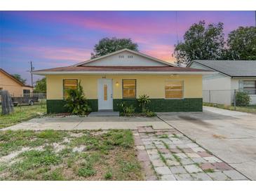 Charming single-story home with a yellow exterior, well-maintained lawn, and inviting entrance at 450 S Buena Vista Ave, Orlando, FL 32835