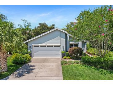 Charming single-story home featuring lush landscaping and a well-maintained two car garage at 125 W Wyndham Ct, Longwood, FL 32779