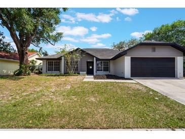 Charming single-story home with a well-maintained lawn and attached two-car garage at 1633 Pinehurst Dr, Casselberry, FL 32707