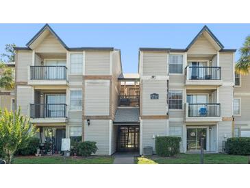 Exterior view of a two-story condo building with balconies and well-maintained landscaping at 1932 Lake Atriums Cir # 69, Orlando, FL 32839