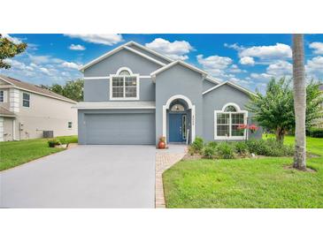 Charming two-story home with a well-manicured lawn, beautiful landscaping, and a blue front door at 2658 Adele Pl, Lake Mary, FL 32746