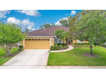 Charming single-story home boasts a well-maintained lawn, mature trees, and inviting curb appeal at 1107 Carringdale Dr, Orlando, FL 32828
