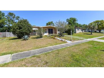 Charming single-story home featuring a well-maintained lawn, a walkway, and simple landscaping at 1732 Oasis Ave, Deltona, FL 32725