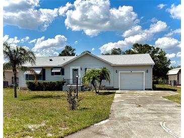Charming single story home featuring a manicured lawn and attached garage, offering comfort and convenience at 204 Holland St, Lake Wales, FL 33859