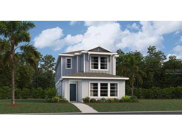 Charming two-story home with a manicured lawn, showcasing its inviting facade and well-maintained landscaping at 7151 Rosy Sky Aly, Orlando, FL 32829