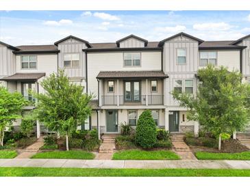 Charming townhouse with well-kept landscaping, gray trim, covered entry, and quaint balcony at 7724 Sweet Star Ave, Orlando, FL 32836