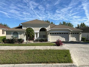Charming single-story home with a three-car garage and well-manicured landscaping at 10955 Lemay Dr, Clermont, FL 34711