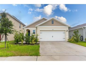 Charming single-story home featuring a two-car garage and well-maintained landscaping with a classic design at 1267 Berry Ln, Davenport, FL 33837