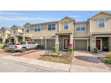 Inviting townhome featuring a private garage and charming front landscaping, showcasing a comfortable and appealing exterior at 3813 Black Spruce Ln, Winter Springs, FL 32708