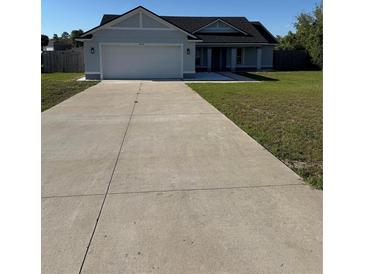 Charming single-story home with a well-manicured lawn and a two-car garage at 468 Marion Oaks Blvd, Ocala, FL 34473