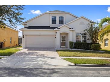 Charming two-story home with a brick driveway and attached two-car garage in a well-maintained community at 558 Cadiz Loop, Davenport, FL 33837