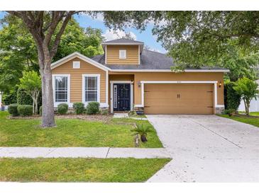 Charming single-Gathering home with a well-manicured lawn, beautiful trees, and a welcoming front door at 805 Gordonia Ct, Deland, FL 32724