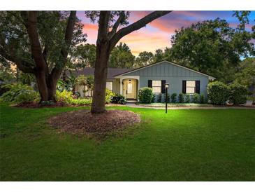 Inviting one-story home at twilight, featuring a lush green lawn and well-maintained landscaping at 1202 Marshall Ct, Eustis, FL 32726