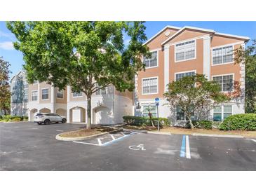 Attractive condo building with attached garages and accessible parking spaces at 12837 Madison Pointe Cir # 206, Orlando, FL 32821