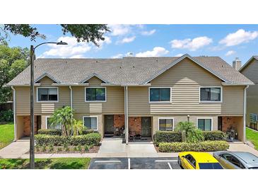 Charming townhome featuring well-maintained landscaping, inviting curb appeal, and convenient parking at 184 Sandlewood Trl # 2, Winter Park, FL 32789
