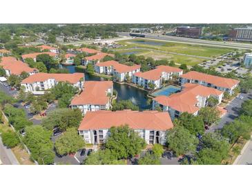 Scenic aerial view of a multi-Gathering community with a pond, fountain and tennis court at 2627 Maitland Crossing Way # 101, Orlando, FL 32810