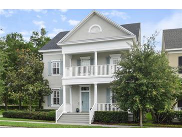 Charming two-story home with a welcoming front porch, columns, blue shutters, and a well-maintained yard at 5303 Brady Ln, Orlando, FL 32814