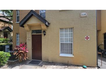 Inviting townhouse featuring a well-maintained exterior and a private entrance at 6316 Raleigh St # 401, Orlando, FL 32835