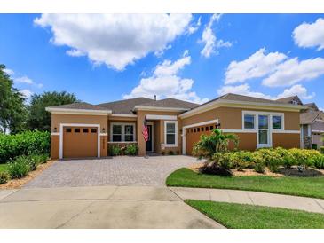 Charming one-story home features a beautifully paved driveway, well-manicured landscaping, and a welcoming entryway at 14830 Winkfield Ct, Winter Garden, FL 34787