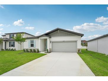 Charming single-story home with a well-manicured lawn and a two-car garage, offering a welcoming curb appeal at 2089 Rosewood Dr, Bartow, FL 33830