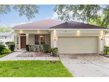 Charming single-story home with a well-manicured lawn and an attached two-car garage at 2280 Yorville Ct, Ocoee, FL 34761