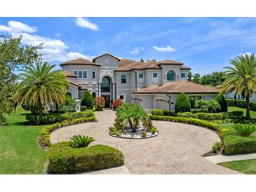 Stately luxury home boasts professional landscaping, circular driveway, and a tile roof at 4071 Isabella Cir, Windermere, FL 34786