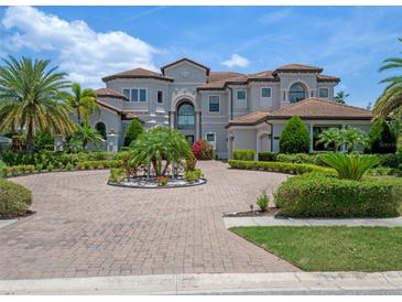 Luxury home boasts professional landscaping, circular driveway, and an attached three-car garage at 4071 Isabella Cir, Windermere, FL 34786