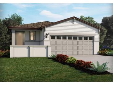 Charming single-story home features a two car garage, neutral color palette and well-manicured lawn at 658 Pennywort St, Lake Alfred, FL 33850