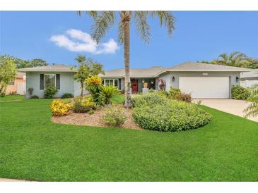 Charming home featuring a lush lawn, mature landscaping and a symmetrical exterior at 8134 Hook Cir, Orlando, FL 32836