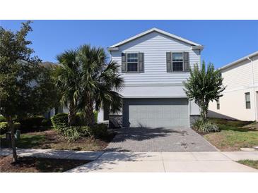 Charming two-story home with a well-maintained lawn and lush landscaping at 8930 Zurich Ln, Kissimmee, FL 34747