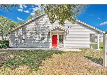Charming home featuring a red front door and screened-in porch at 9616 River Walk Ct, Orlando, FL 32825