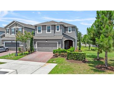 Charming two-story home features a well-manicured lawn and an inviting entrance with a brick driveway at 1425 Paget Cv, Sanford, FL 32771
