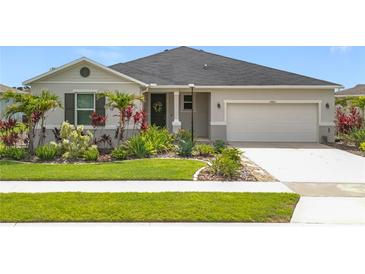 Charming single-story home with a well-manicured lawn and colorful landscaping at 15865 Bradicks Ct, Clermont, FL 34711