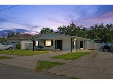 Charming single-story home with a well-manicured lawn, swing, and spacious driveway at 1623 Cumbie Ave, Orlando, FL 32804